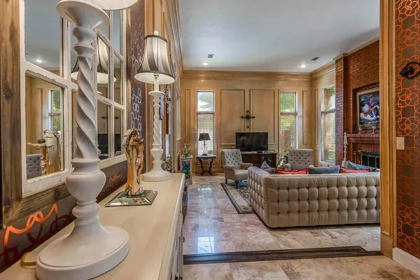 a living room with furniture a fireplace and a flat screen tv