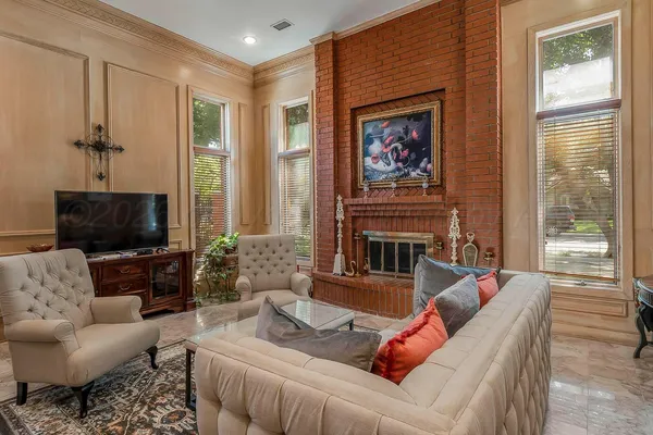 a living room with furniture and a ceiling fan