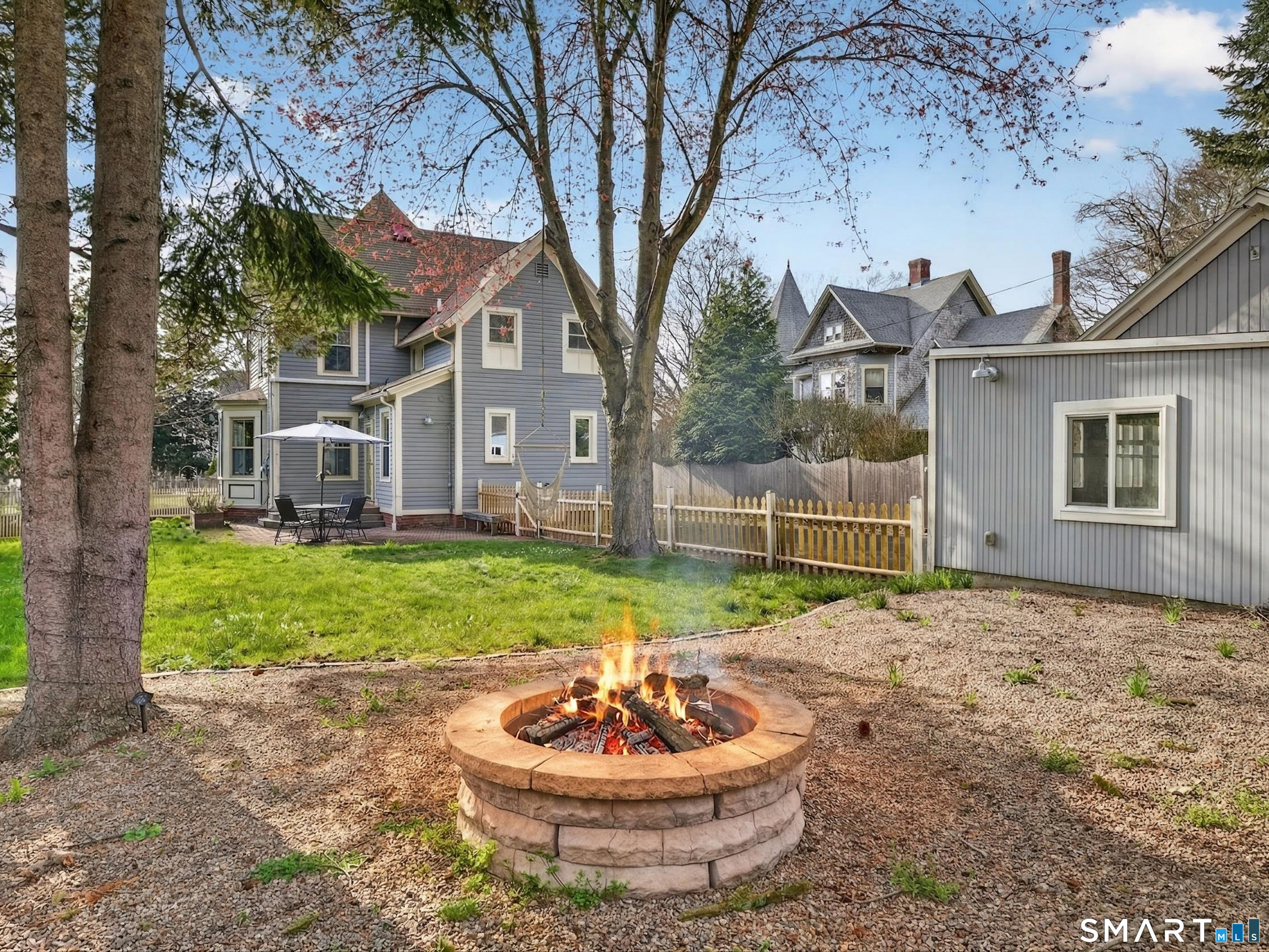 68 Ramsdell Street Groton, CT 06340 - Photo 30 of 31 a view of a house with a yard fire pit and a large tree