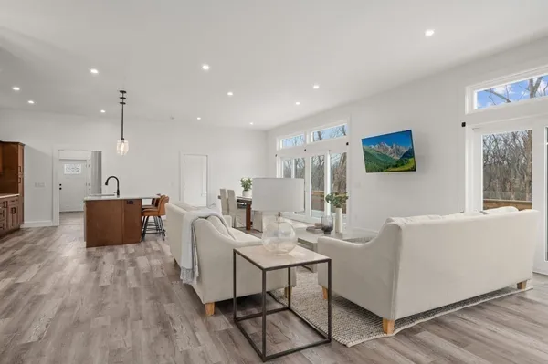 a living room with furniture kitchen view and a table