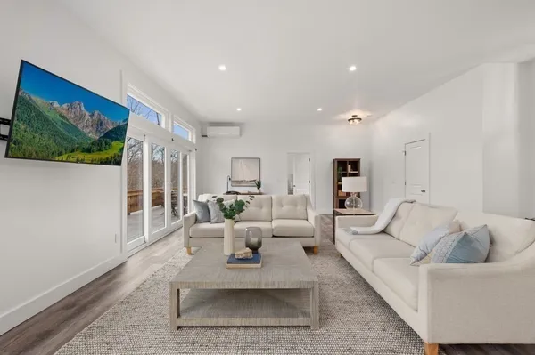 a living room with furniture and large windows