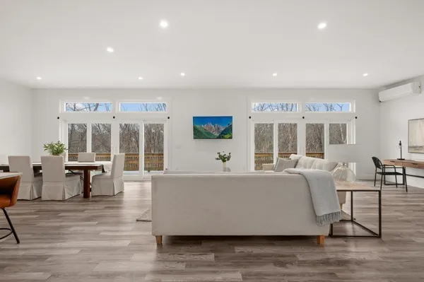 a living room with furniture and large windows