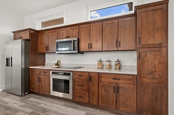 a kitchen with stainless steel appliances granite countertop a sink stove and refrigerator