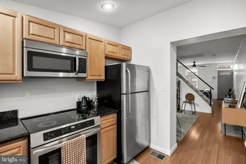 a kitchen with stainless steel appliances a refrigerator microwave and stove