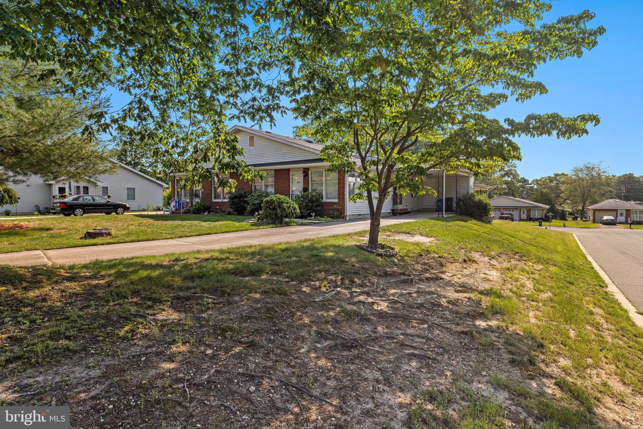 43B Sycamore Access Road Manahawkin, NJ 08050 - Photo 33 of 40 a view of a house with a yard and tree s