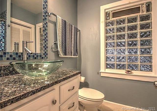 15 Merwin Avenue Milford, CT 06460 - Photo 12 of 23 a bathroom with a granite countertop sink a toilet a mirror and window