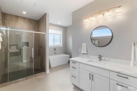 a bathroom with a bathtub and shower