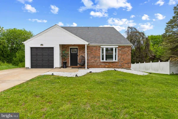 a view of a house with a yard and tree s