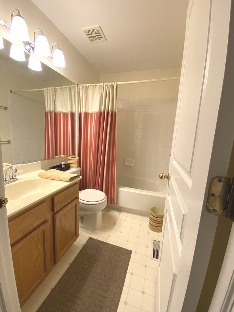 418 Cardinal Drive Bartlett, IL 60103 - Photo 20 of 29 a bathroom with a sink a toilet a mirror and shower