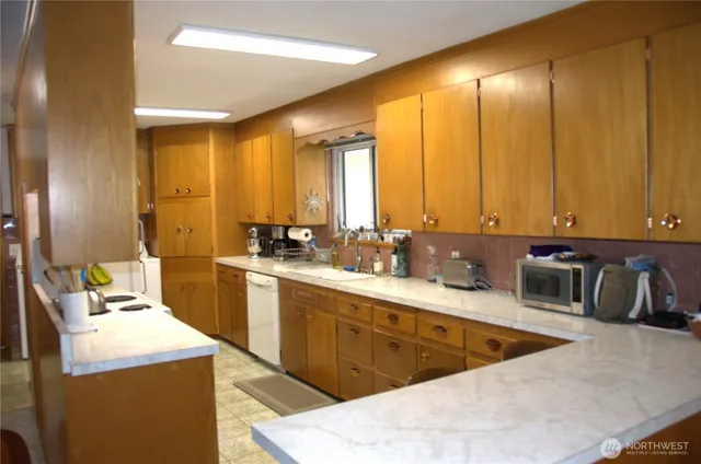 a kitchen with sink and refrigerator