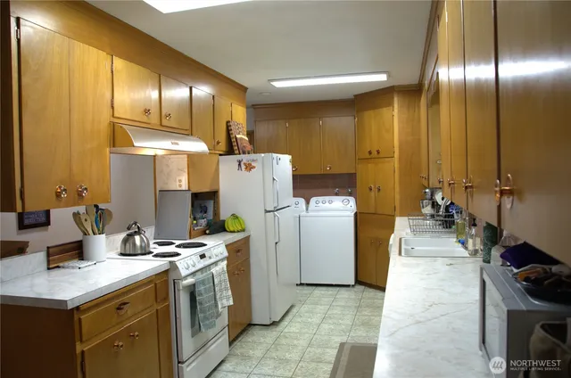 a kitchen with a sink a refrigerator and a stove