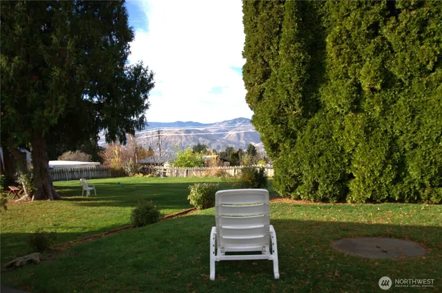 a view of a table and chairs in the garden