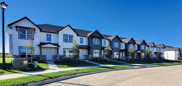 a front view of a house with a yard table and chairs