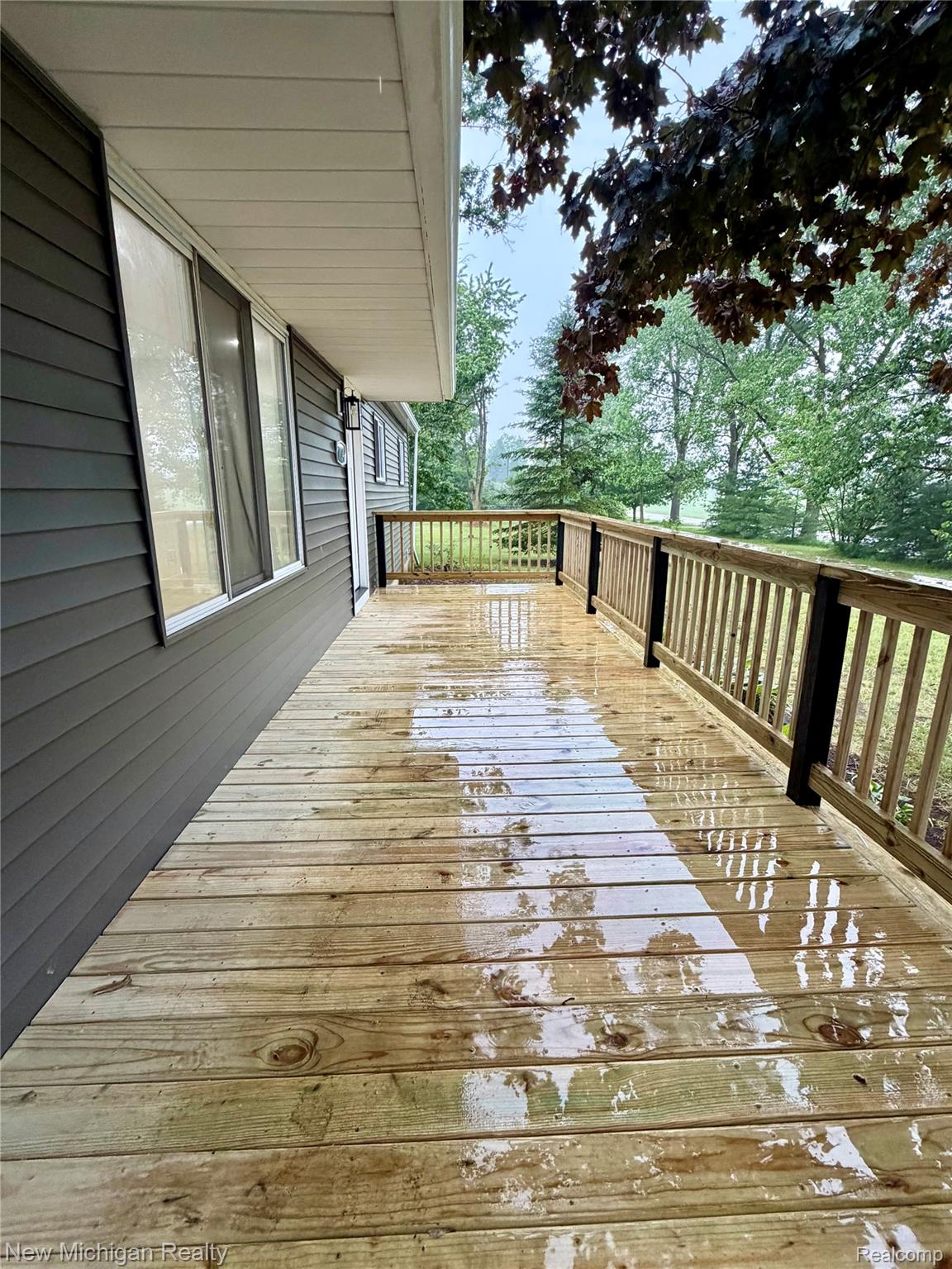 7104 Willard Road Millington, MI 48746 - Photo 2 of 30 Expansive wood deck featuring natural wood railings with black posts