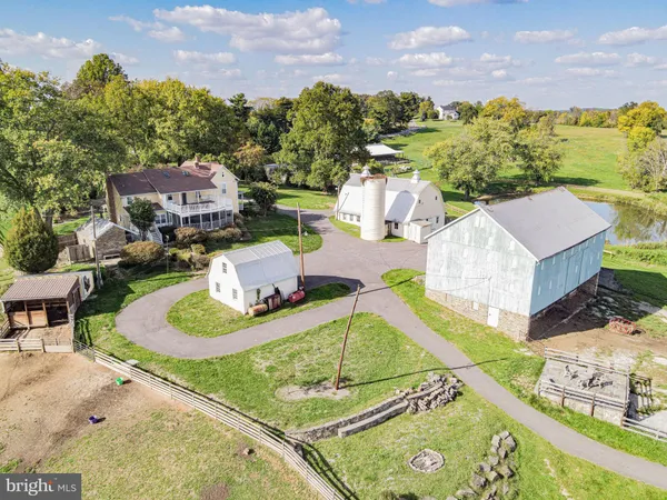 a view of house with a yard patio and fire pit