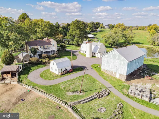 a view of house with a yard patio and fire pit