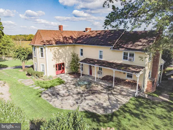 a view of a workspace with furniture and window