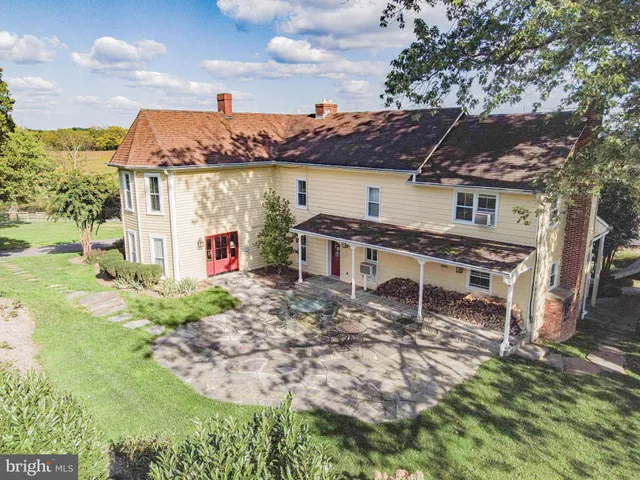 a view of a workspace with furniture and window