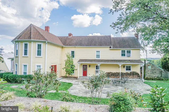 a living room with furniture a flat screen tv and large windows