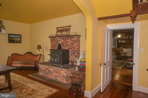 a kitchen with stainless steel appliances granite countertop a refrigerator a sink dishwasher a stove top oven a kitchen island and cabinets with wooden floor