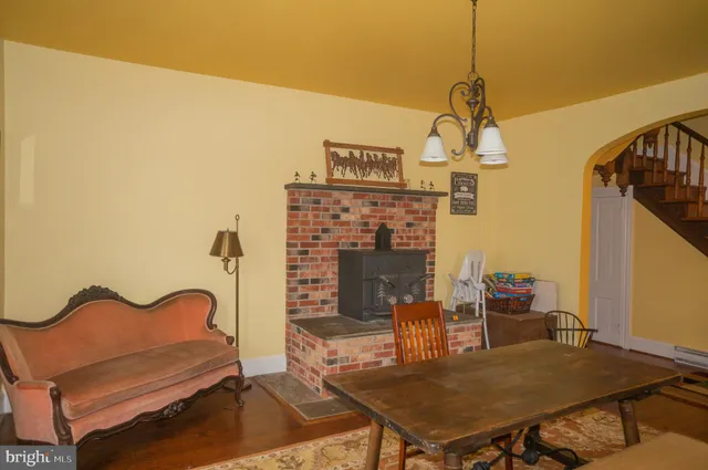 a view of a patio with table and chairs with wooden floor and fence