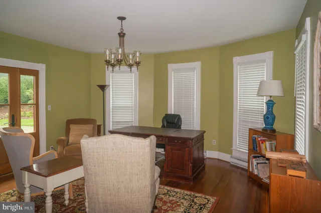 a bedroom with two beds and a chandelier