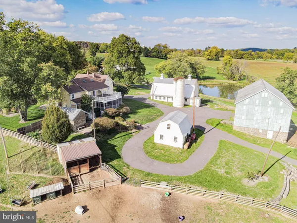 a aerial view of a house with a yard and large tree