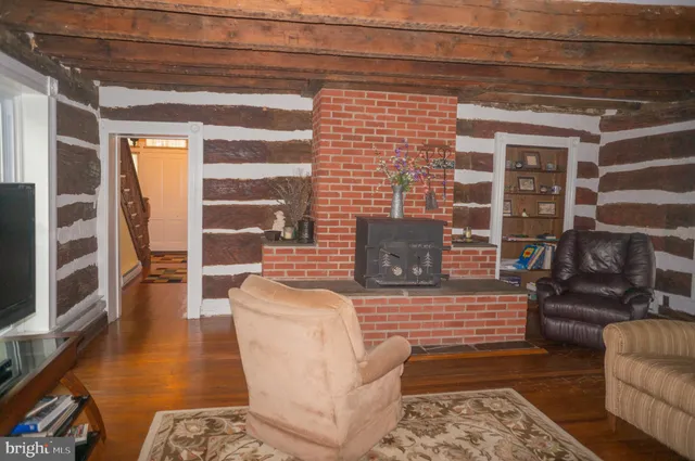 a view of a swimming pool with lawn chairs and a big yard