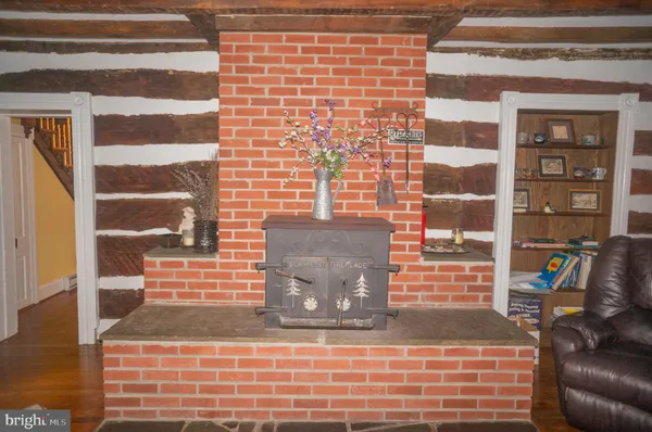 a view of a house with a big yard and a large tree