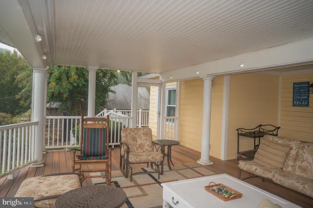 a view of a big house in a big yard with large trees