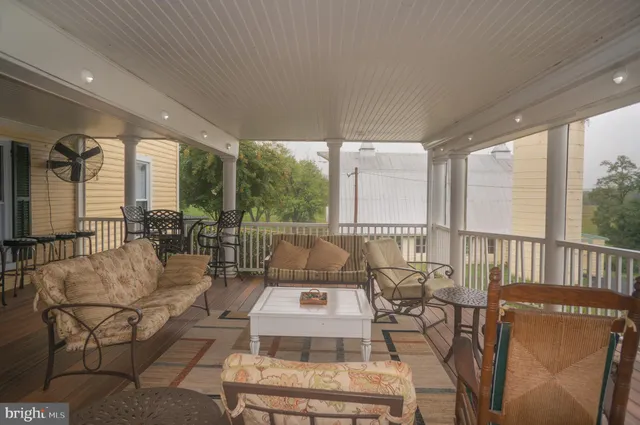 an aerial view of a house with outdoor space and a lake view