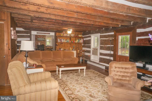 a front view of a house with a yard and potted plants