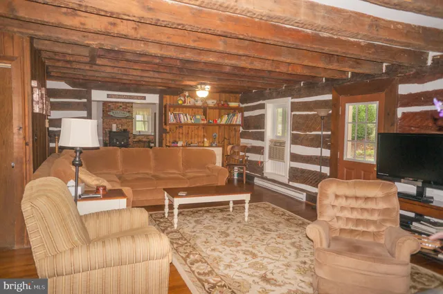 a front view of a house with a yard and potted plants