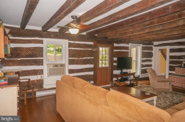a view of a small house with wooden fence