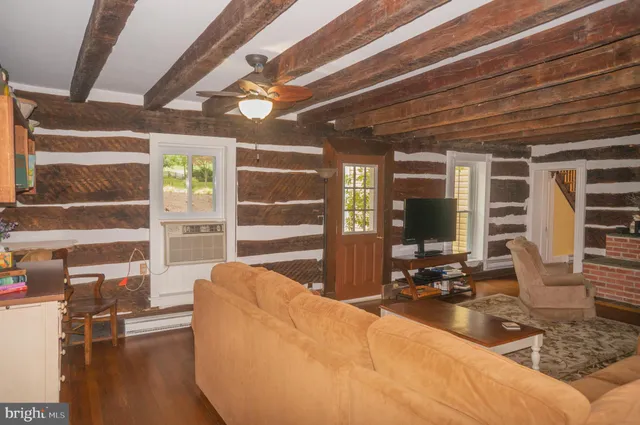 a view of a small house with wooden fence