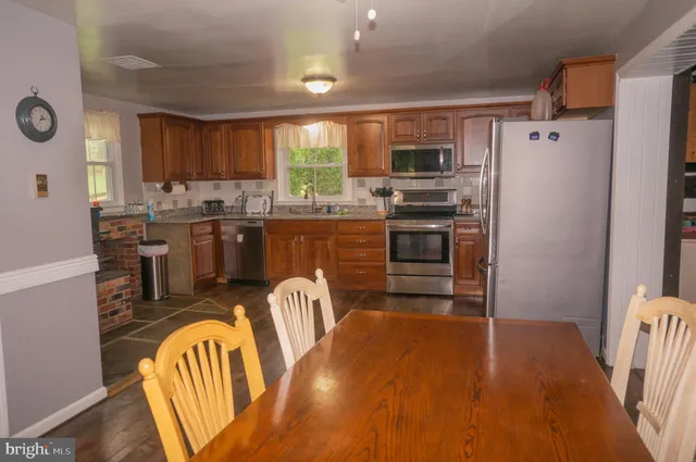 a view of a room with wooden floor and windows