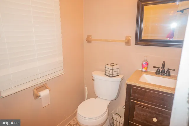 a bathroom with a sink a mirror and a toilet