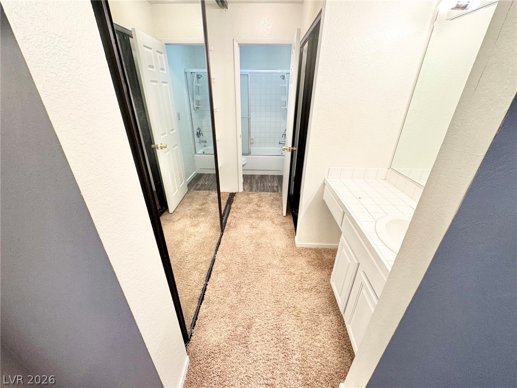 6250 West Flamingo Road, Unit 109 Las Vegas, NV 89103 - Photo 10 of 18 A well-appointed vanity area with a mirrored wall offering ample grooming space.