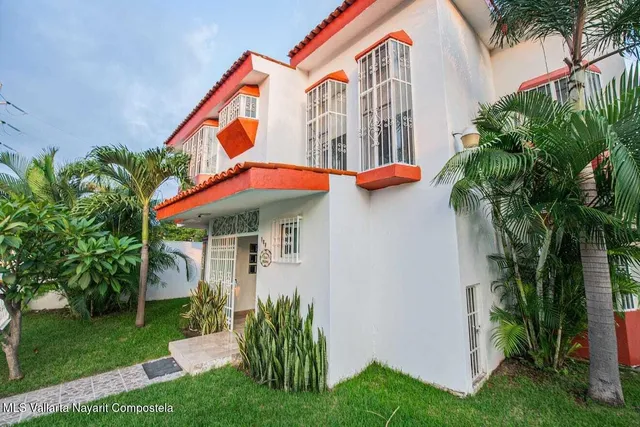 a view of a house with a yard and plants