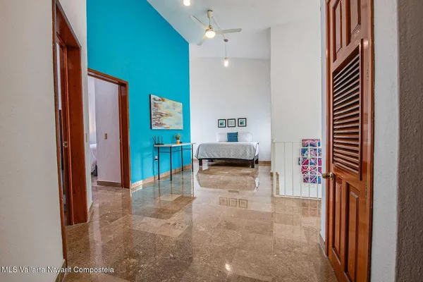 a view of a hallway with dining area and chandelier