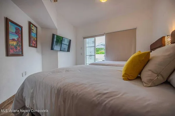 a bedroom with a bed and painting on the wall