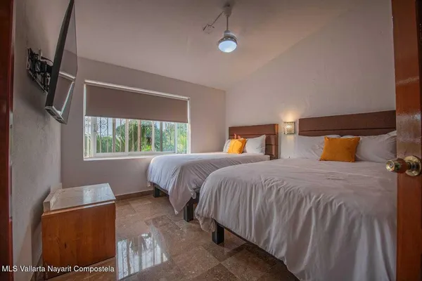 a bedroom with a bed and window