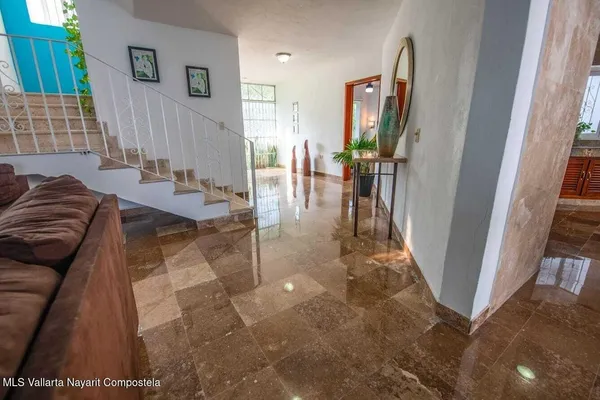 a view of a hallway with couches and potted plant