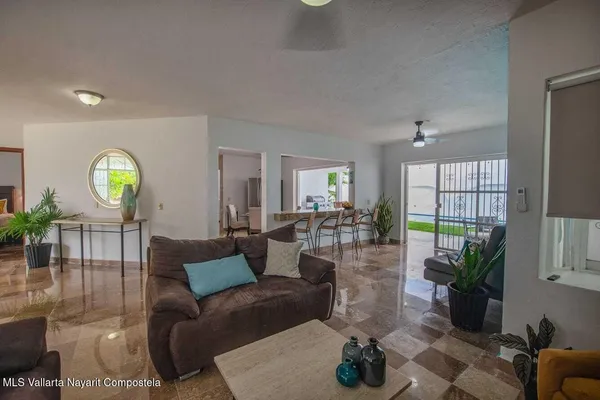 a living room with fireplace furniture and a potted plant