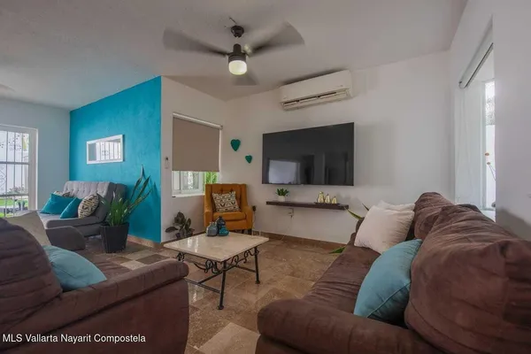 a living room with furniture and a flat screen tv