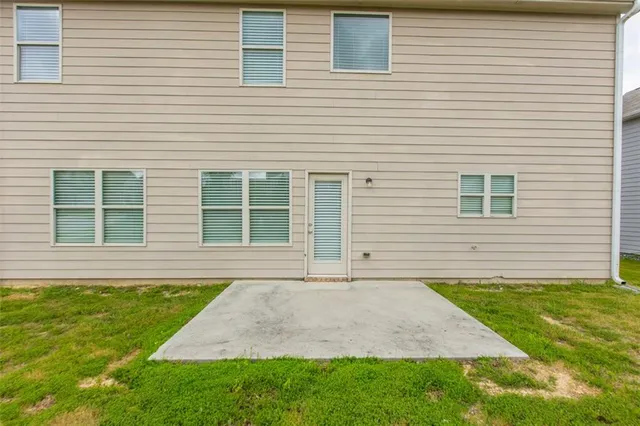 a view of an house with backyard space and balcony