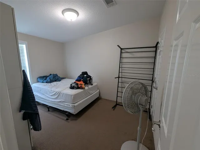 a bed room with a bed and a window