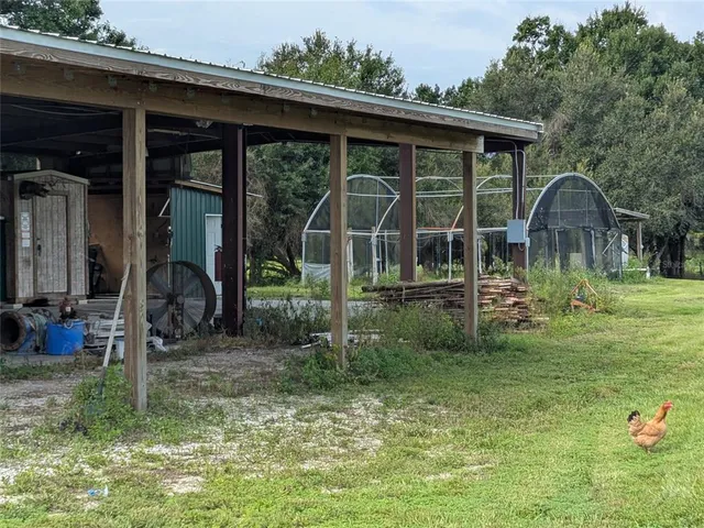 a backyard of a house with barbeque oven