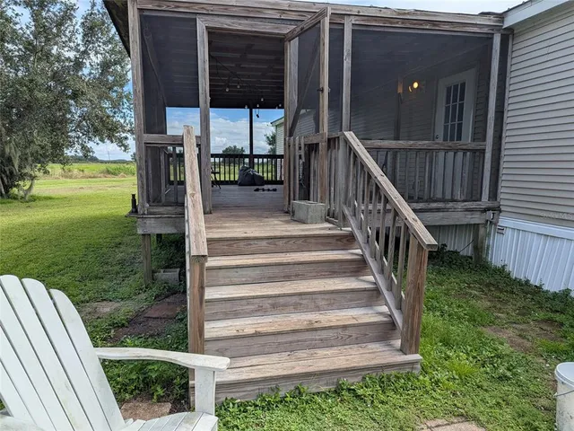 a view of backyard with seating space and wooden fence