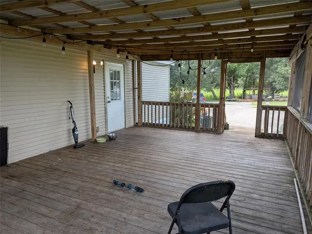 a view of a porch with furniture and a yard